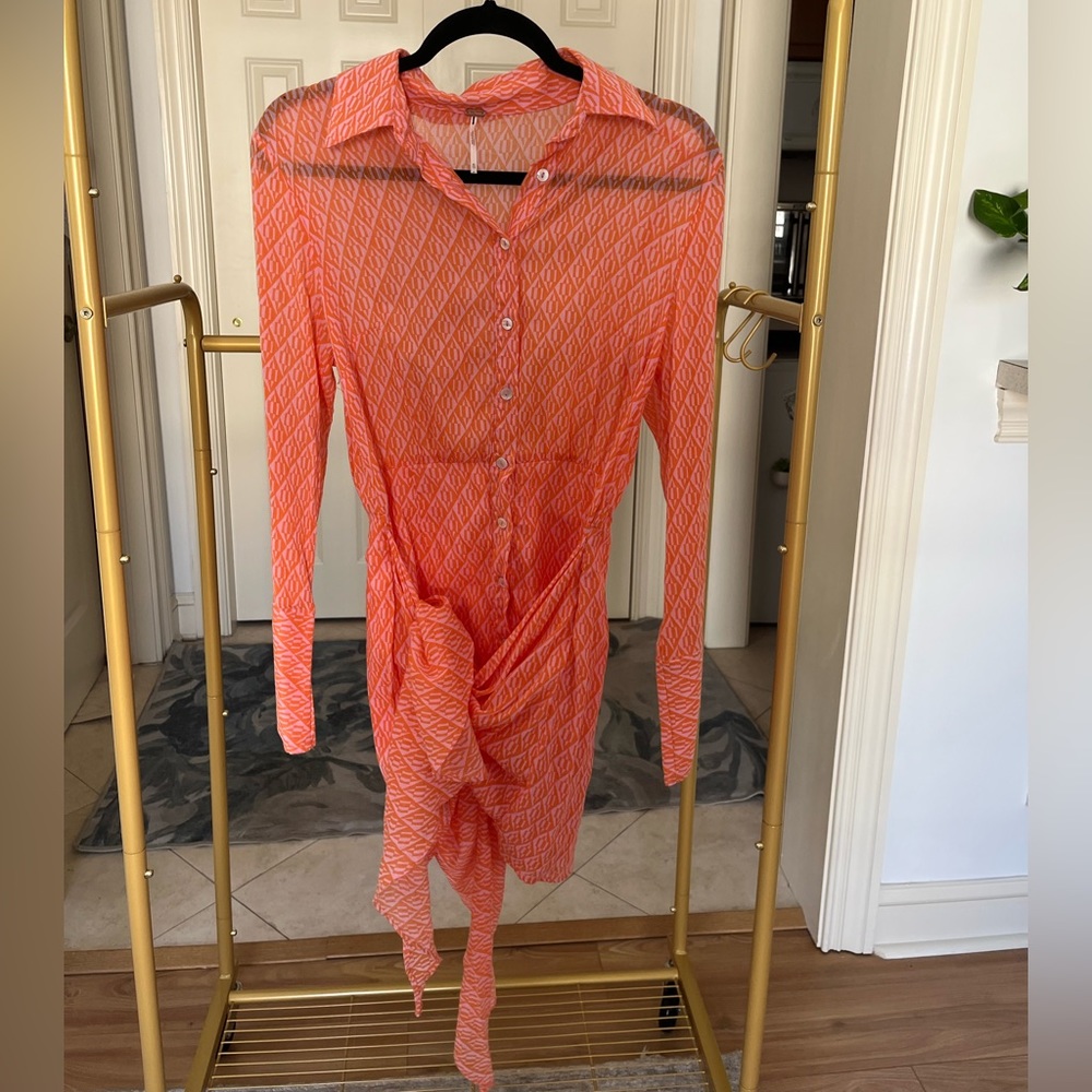 Never worn- Free People button up dress with ties/fabric detail on skirt.